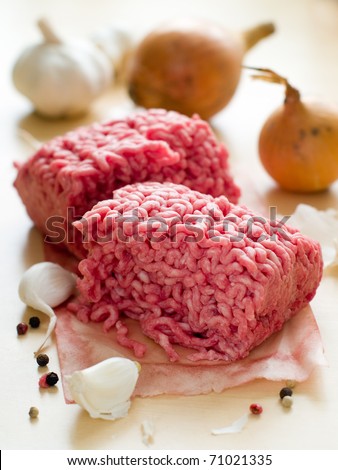 Minced meat in butcher paper with onion and garlic