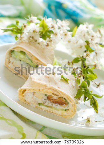 Sandwich Wrap with cheese, cucumber, lettuce and smoked salmon  in a whole wheat tortilla wrap