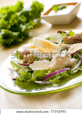 A fresh and light salad with egg and smoked fish. Shallow depth of field, selective focus