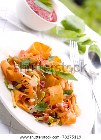Tagliatelle pasta with tomato and vegetable sauce. Selective focus