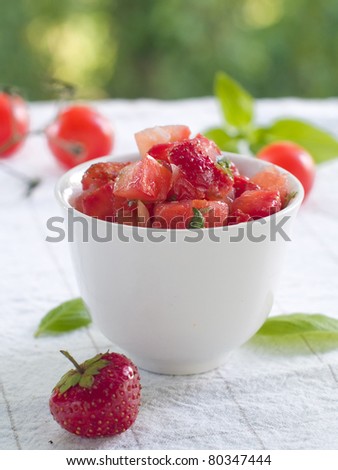 Tomato and strawberry salsa in bowl. Selective focus