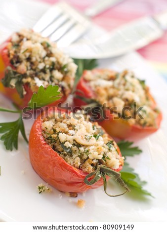 Stuffed tomato with crumble. Shallow doff, selective focus .