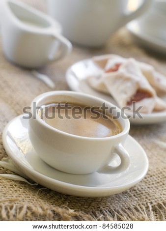 Fresh coffee with milk in cup  with cookie close up. Selective focus