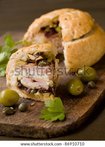 Sandwich with ham, bacon, cheese and olive salad. Selective focus