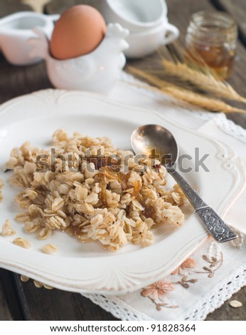 A plate of warming porridge, with  honey, selective focus