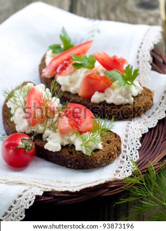 Bread with cottage cheese and tomatoes, selective focus