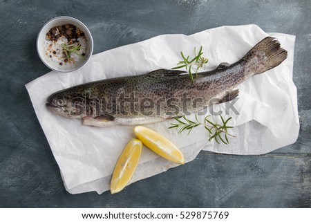 Delicious fresh fish (trout) on vintage background for healthy food, diet or cooking concept, selective focus