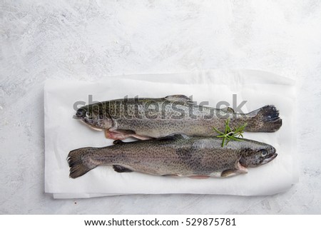 Delicious fresh fish (trout) on vintage background for healthy food, diet or cooking concept, selective focus