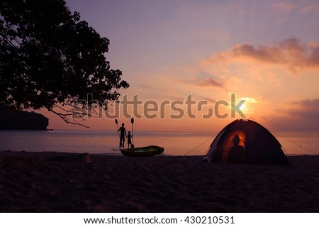 Camping on the beach with the shadow of the women in the tent and The men with daughter standing near the kayak at ang thong Island.