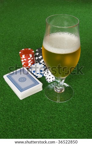 Poker table with chips beer dices and cards