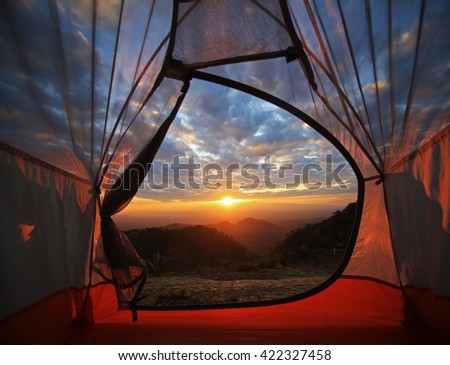 A camping tent glows under sunset to a night sky  Outdoor Camping adventure
