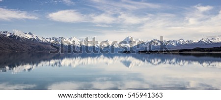 New Zealand mountain reflect on turquoise lake with blue sky