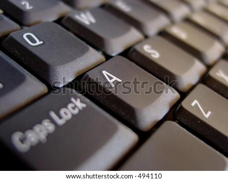 dark grey or black computer laptop keyboard diagonal focus on letter a.