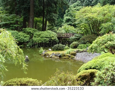 Japanese garden with pond small lake in foreground - stock photo