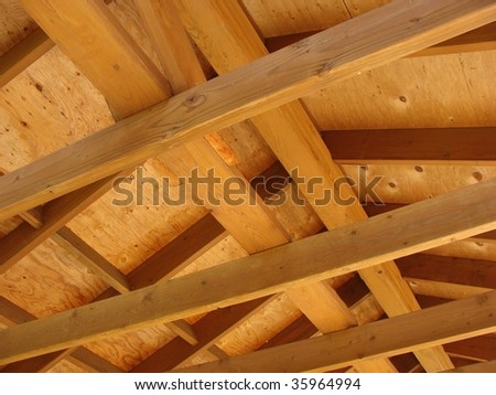 Timber beam construction looking up into roof