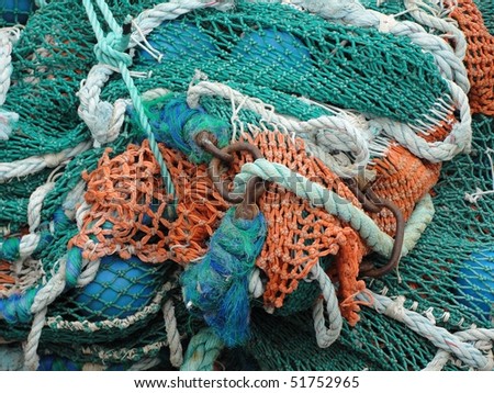 Sea fishing nets in a colorful pile of green red and white