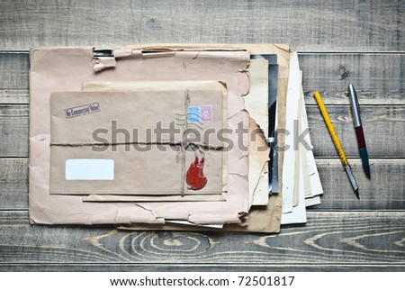 Old envelopes with papers and pens