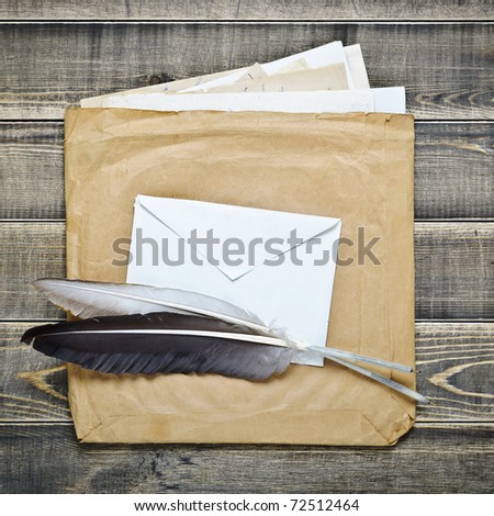 quill feathers and old envelopes with paper