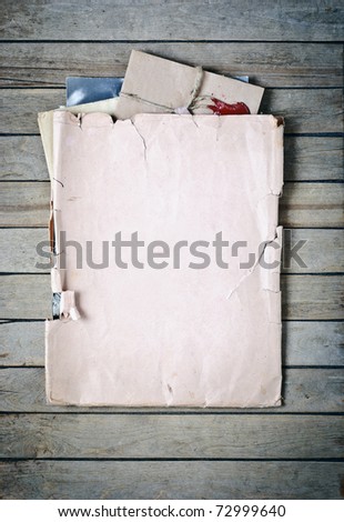 Old envelope with papers a on wooden planks background