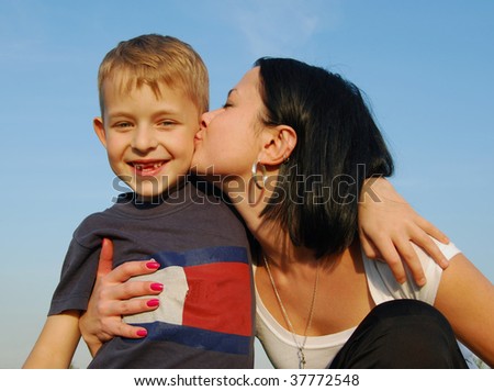 Young mother kissing her son