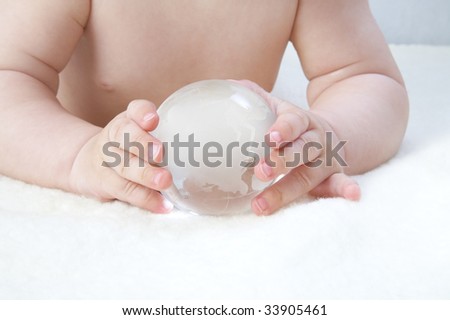 Glass sphere in small hands of the child