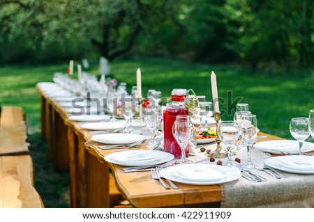 Decorated wedding table with candles in the garden