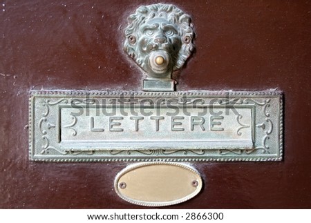 Ancient italian letter box on a door with 'lettere' text