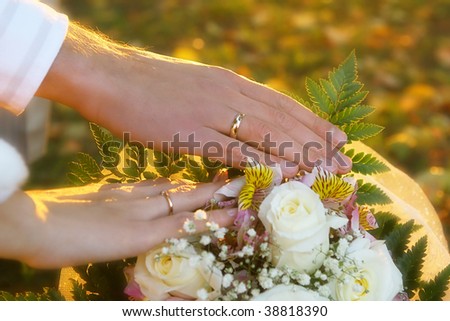 stock photo Wedding rings and bunch of flowers