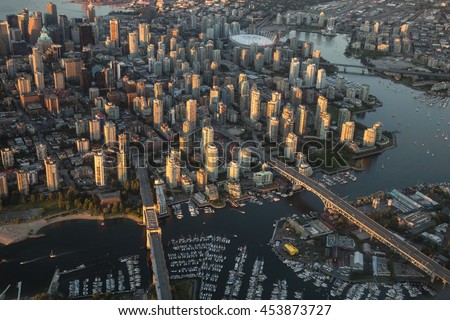 Aerial Photography of False Creek, Cambie Bridge and Granville Bridge in Downtown Vancouver, BC, Canada, on a Hazy sunny sunset.