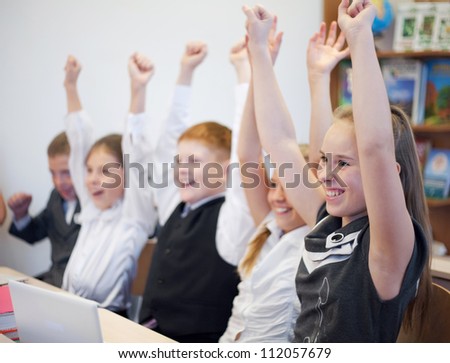 Schoolchildren showing success and rising hands