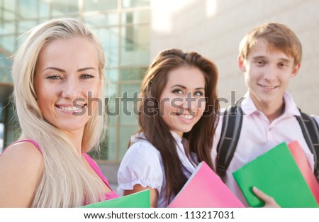 Smart students hold the books near college