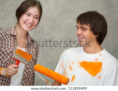 Happy couple while painting room