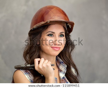 Young female engineer holding pliers