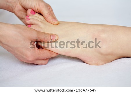Therapist doing feet acupressure  massage
