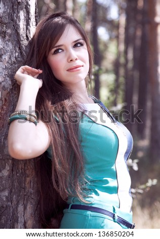 Beautiful young woman in summer forest