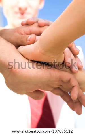 Business partners hands on top of each other