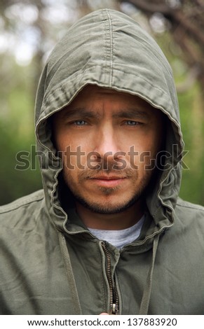 Close-up of serious man in hood  outdoor