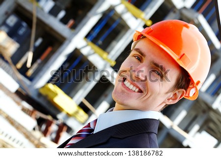 Happy engineer in helmet while building