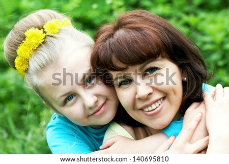 Happy daughter embracing her mother in natural environment
