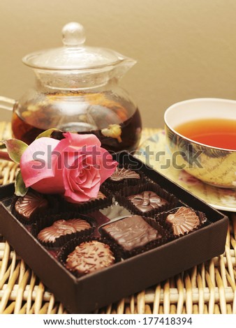 Teapot and teacup with rose on box of chocolate