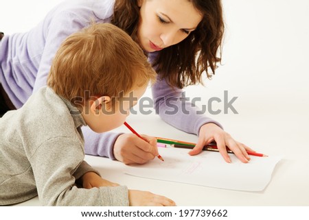 Mother teaching to draw small boy