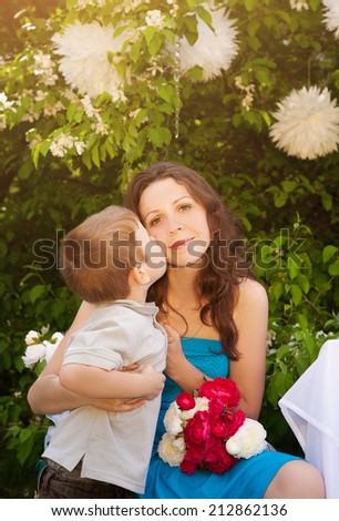 Boy kissing his mom during mothers day