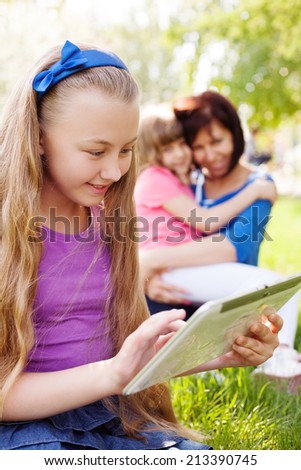 Education concept: smiling girl using digital tablet