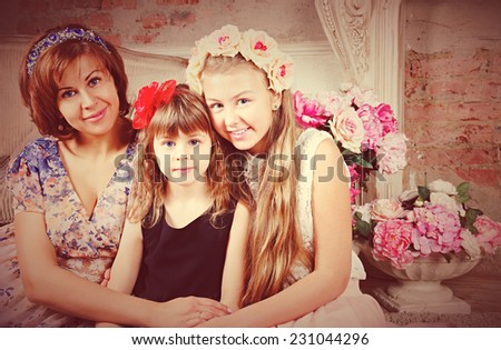 Portrait retro of family: woman with two daughters
