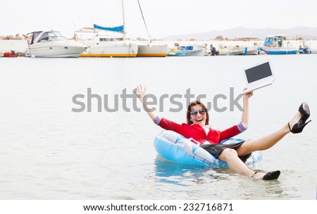 Cheerful businesswoman floating in ocean- business success