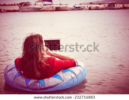 Rear view of business woman floating in the sea