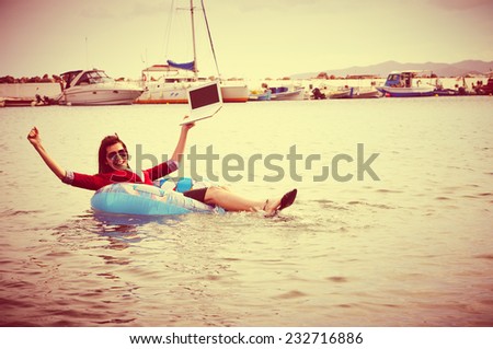 Cheerful businesswoman floating in ocean- business success