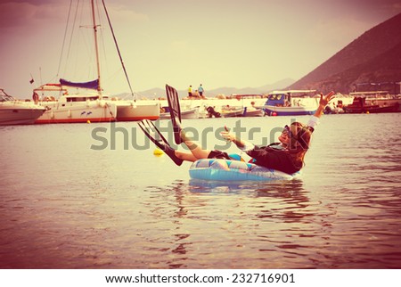 Happy  businesswoman in flippers floating in ocean- retro