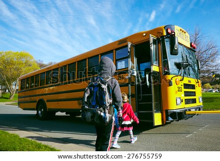 EAU CLAIRE, USA â?? April 29, 2015. American children getting on the schoolbus