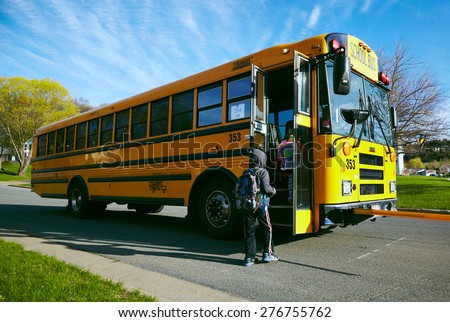 EAU CLAIRE, USA â?? April 29, 2015. American children getting on the schoolbus